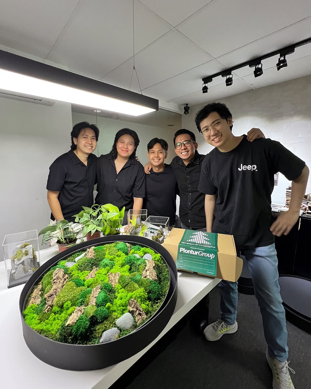 Studio Hábil team with circular moss installation